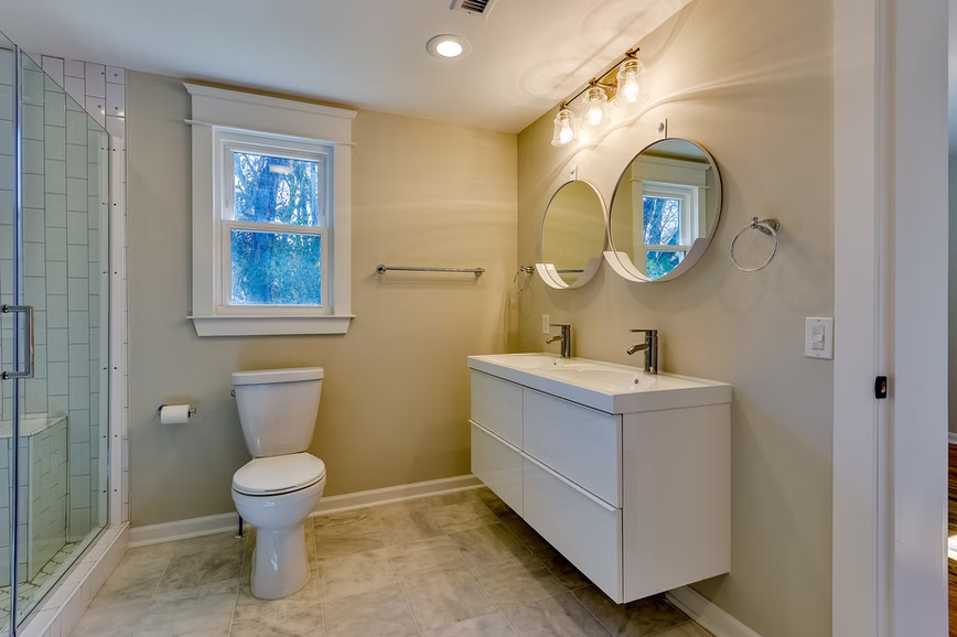 Bathroom with coordinated fixtures, tile, and vanity finishes