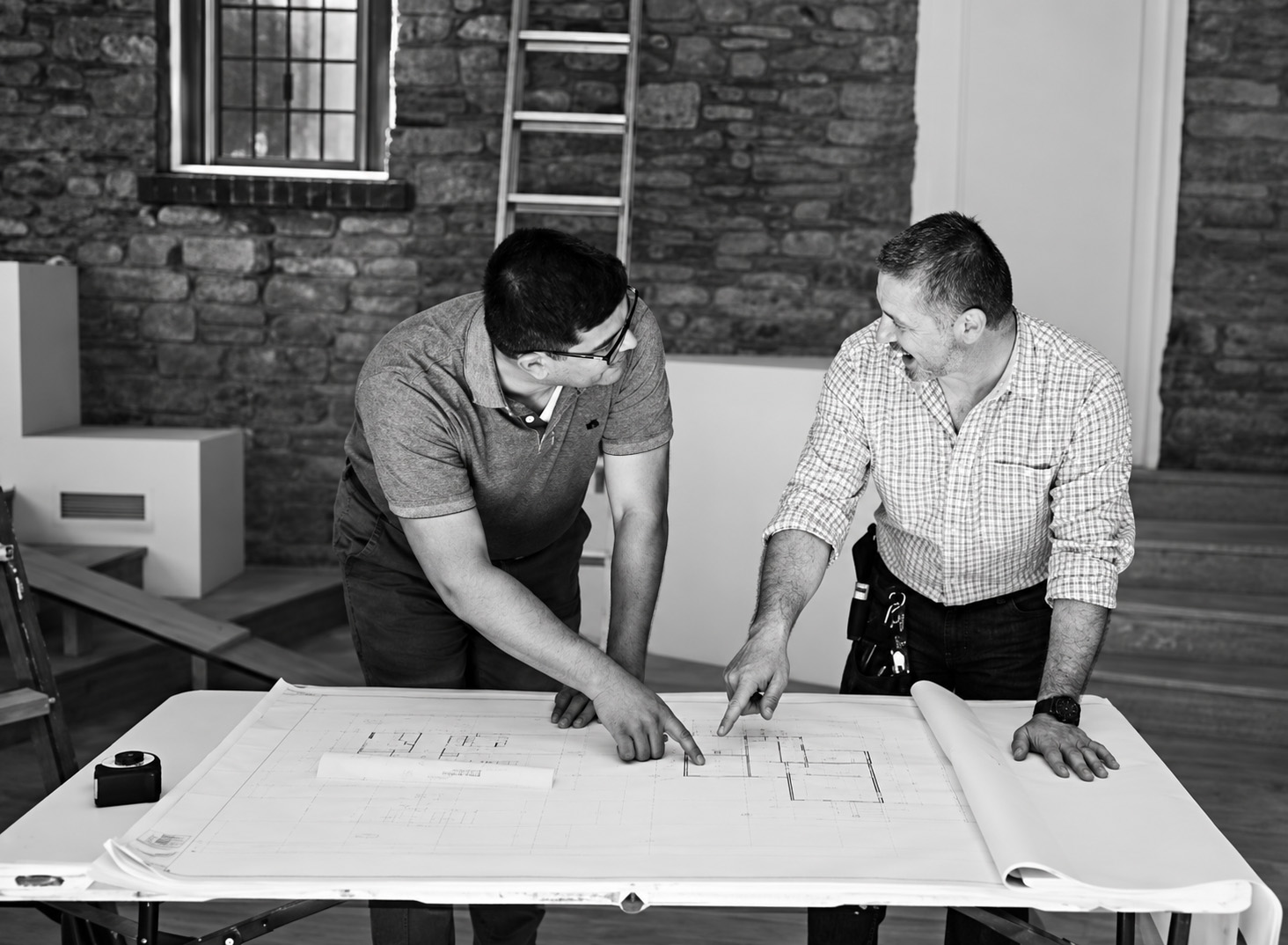 Construction planning documents reviewed at a work table