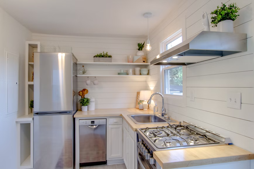 Kitchen with an island, coordinated cabinetry, and pendant lighting